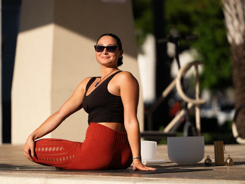 Jessica Szabo seated in an outdoor private yoga session
